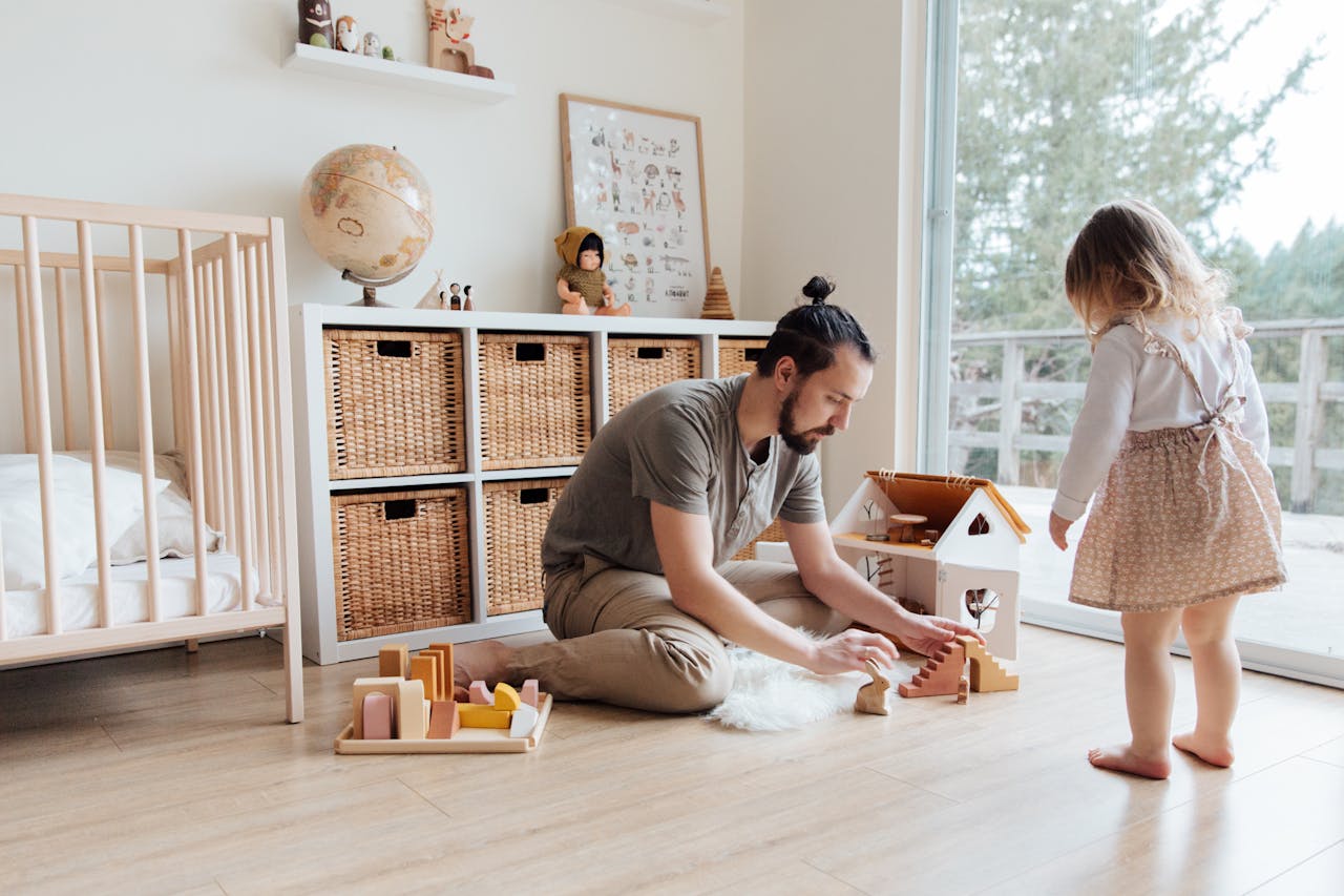 Father engaging with daughter in a playful indoor setting, building memories.
