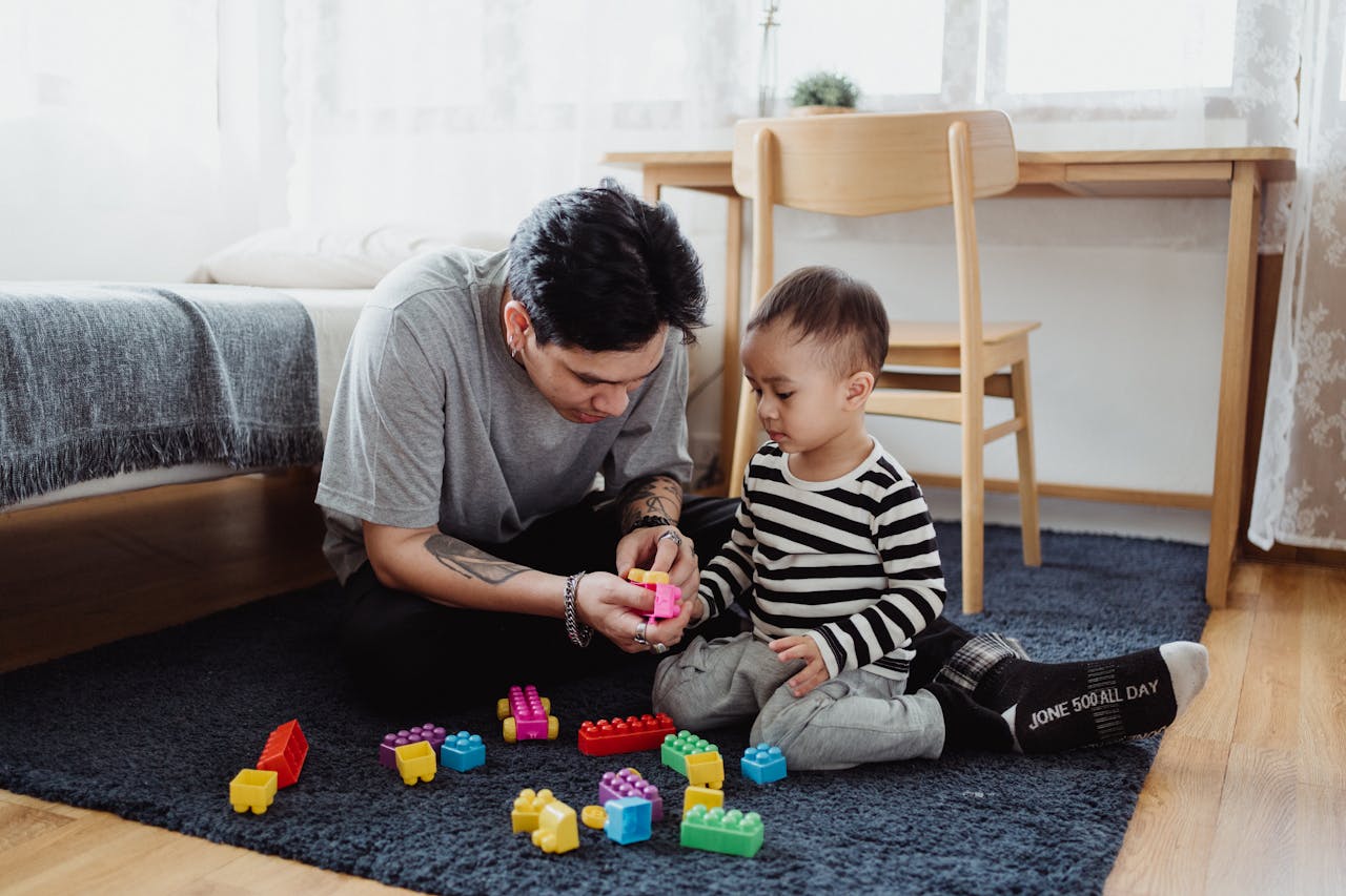 Category Father and son bonding over colorful building blocks in a cozy room.
